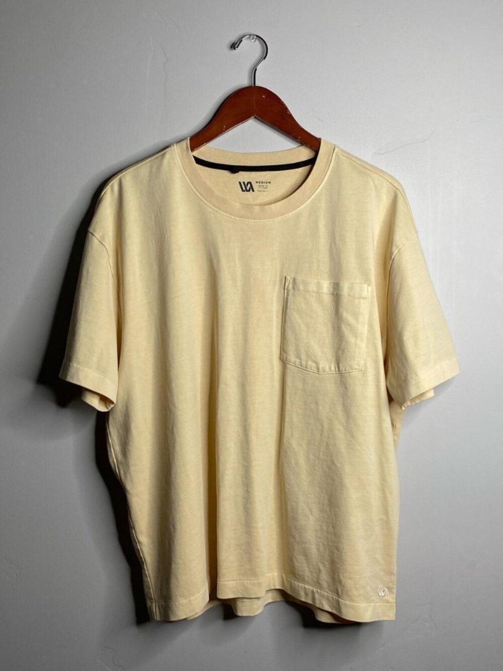 Size medium, runs big check measurements yellow tee with front pocket